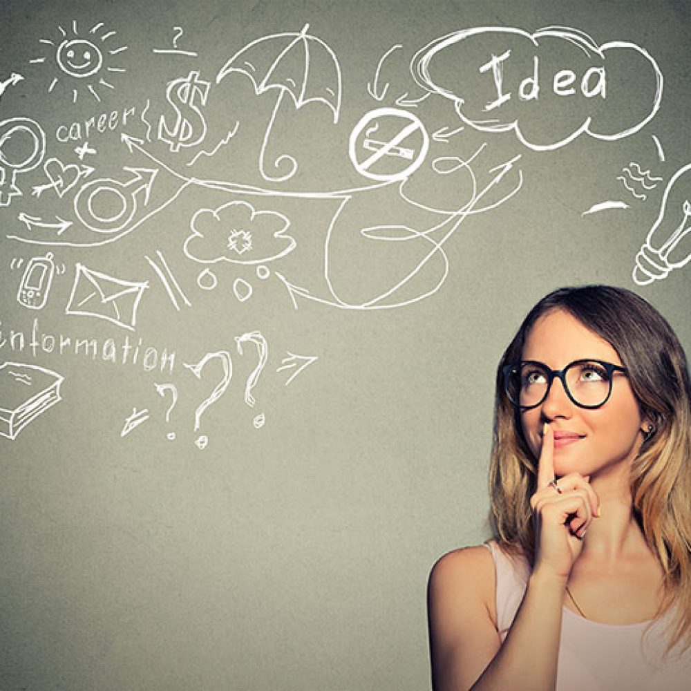 Portrait happy young woman thinking dreaming has many ideas looking up isolated grey wall background. Positive human face expression emotion feeling life perception. Decision making process concept.